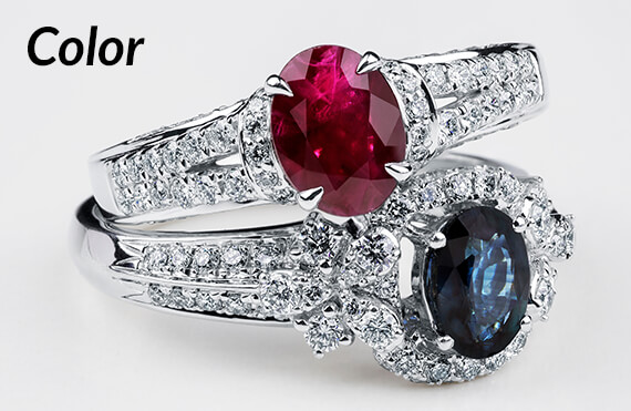 Color Jewelry - image of a ruby and diamond ring stacked on top of a sapphire and diamond ring