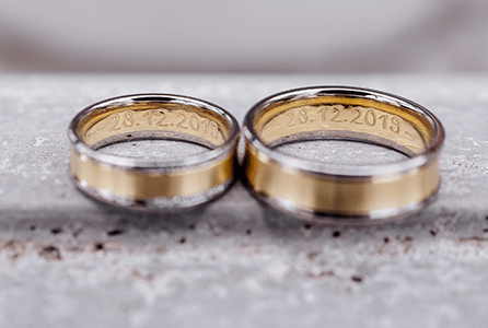 wedding dates engraved on the insides of a pair of wedding bands