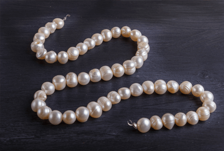 pearl necklace sitting on a table top