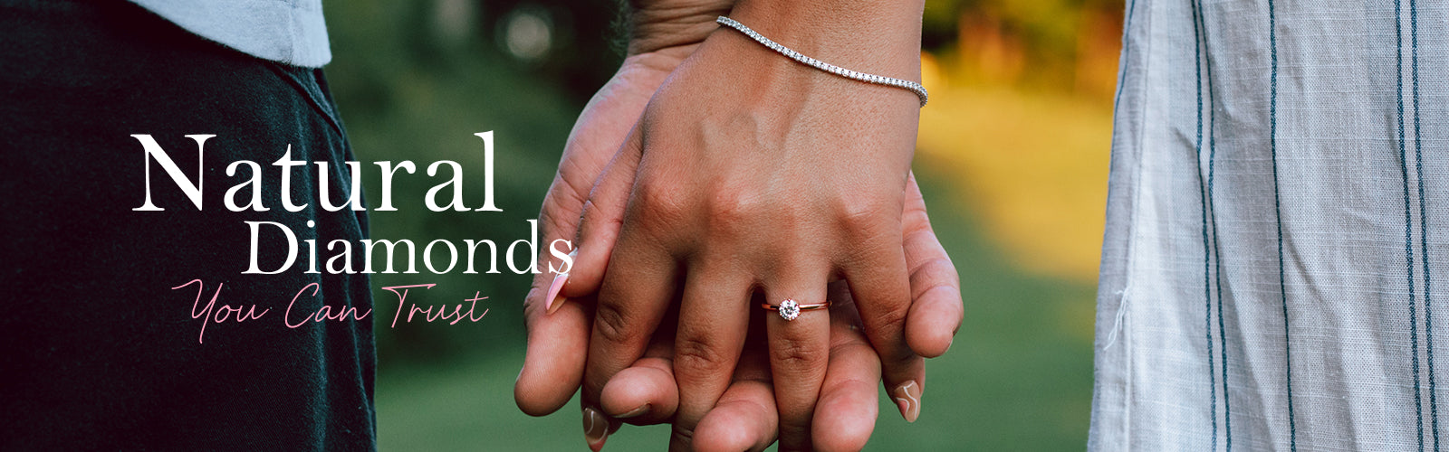 Natural Diamonds You Can Trust - text overlaying image of a couple holding hands, one with an engagement ring